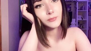 Emi paints her lips & caresses her breasts